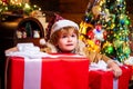 Child with big gift box. Merry Christmas and Happy Holidays. Kids enjoy the holiday. Christmas interior. Cute little Royalty Free Stock Photo