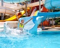 Child in bikini sliding water park