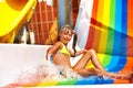 Child in bikini sliding water park.