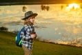 Child with binoculars travelling outdoors. Boy traveler with backpack in a summer day. Portrait of a little boy