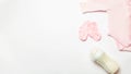 Child birth concept. Accessories and clothes for newborn girl. Set of baby bodusuit and socks, booties on white background. Top Royalty Free Stock Photo