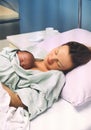 Child birth in maternity hospital. Mother and newborn. Young mom hugging her newborn baby after delivery. Woman giving birth Royalty Free Stock Photo