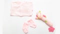 Child birth. Pink clothes for little girl - bodusuit and socks. Accessories for newborn. Baby thing and toy on white background. Royalty Free Stock Photo