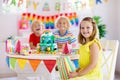 Child birthday party. Kids blow candle on cake Royalty Free Stock Photo