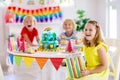 Child birthday party. Kids blow candle on cake Royalty Free Stock Photo