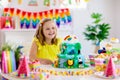 Child birthday party. Kids blow candle on cake Royalty Free Stock Photo