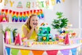 Child birthday party. Kids blow candle on cake Royalty Free Stock Photo