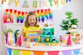 Child birthday party. Kids blow candle on cake Royalty Free Stock Photo