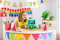 Child birthday party. Kids blow candle on cake Royalty Free Stock Photo