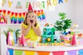 Child birthday party. Kids blow candle on cake Royalty Free Stock Photo