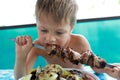 Child biting kebab Royalty Free Stock Photo