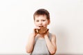 A child bitten by a pancake on a white background