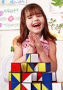 Child with block in play room. Royalty Free Stock Photo