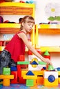 Child with block in play room. Royalty Free Stock Photo