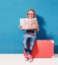 Child blonde girl with pink vintage suitcase and city map ready for summer vacation. Travel and adventure concept Royalty Free Stock Photo