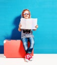 Child blonde girl with pink vintage suitcase and city map ready Royalty Free Stock Photo