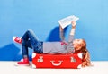 Child blonde girl with pink vintage suitcase and city map ready Royalty Free Stock Photo