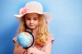 Child blonde girl study the globe. Travel and adventure concept