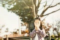 Child blowing a dandelion in a park Royalty Free Stock Photo