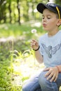 Child blowing dandelion seeds outdoor Royalty Free Stock Photo