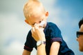 Child blowing nose. Boy with tissue. Catarrh or allergy