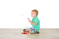 Child blowing soap bubbles in white background