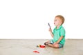 Child blowing soap bubbles in white background