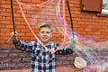 Child Blows A Big Soap Bubble. Independent Games With Children