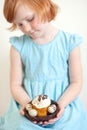 Child holds an Easter cake