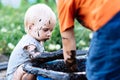 Child playing in the mud on the street Royalty Free Stock Photo