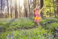 Child with bluebell flowers in spring forest Royalty Free Stock Photo