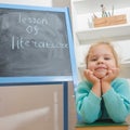 Child with a book near the chalk Board Royalty Free Stock Photo