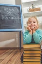 Child with a book near the chalk Board Royalty Free Stock Photo