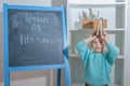 Child with a book near the chalk Board Royalty Free Stock Photo