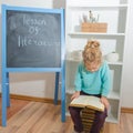 Child with a book near the chalk Board Royalty Free Stock Photo