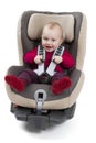 Child in booster seat for a car in light background