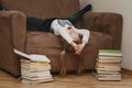 The child is bored lying in a wide chair. Royalty Free Stock Photo