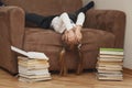 The child is bored lying in a wide chair. Royalty Free Stock Photo