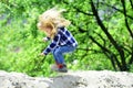 Child bounce on sand in spring or summer park Royalty Free Stock Photo