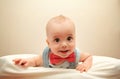 Child with bowtie lying on the bed