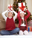 Child with box gift in christmas decoration at home, happy emotion, winter holiday concept