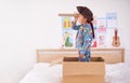 Child, box and pirate hat with spyglasses on bed in home for play, adventure and game as creativity. Boy, cardboard and Royalty Free Stock Photo