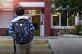 Child boy with bag go to elementary school. Back view Royalty Free Stock Photo