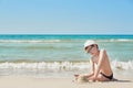 Child boy on beach. Rest on vacation, play in sand against sea. Tourism and vacation on ocean. Family vacation in summer. Vacation Royalty Free Stock Photo