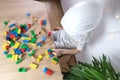 Child, a boy in a builder`s helmet plays with colored wooden cubes, builds houses and rockets, the concept of the development of Royalty Free Stock Photo