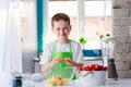 Child boy cracking egg and separating the yolk Royalty Free Stock Photo