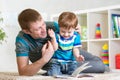 Child boy and dad read a book on floor at home Royalty Free Stock Photo