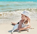 Child boy with dog jack russel on beach. Best friends rest on vacation, play in sand against sea. Tourism and vacation on ocean. Royalty Free Stock Photo