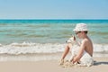 Child boy with dog jack russel on beach. Best friends rest on vacation, play in sand against sea. Tourism and vacation on ocean. Royalty Free Stock Photo