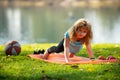 Child boy is doing push up exercise in spring park. Healthy activities kids lifestyle. Strong child exercising in park Royalty Free Stock Photo